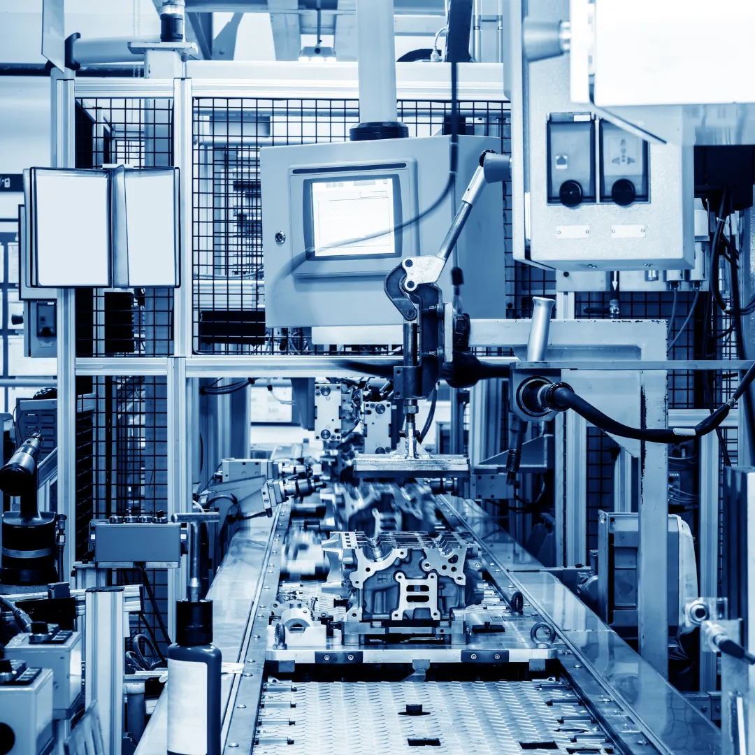 Close-up view of an automated assembly line with various mechanical components and electronic equipment.
