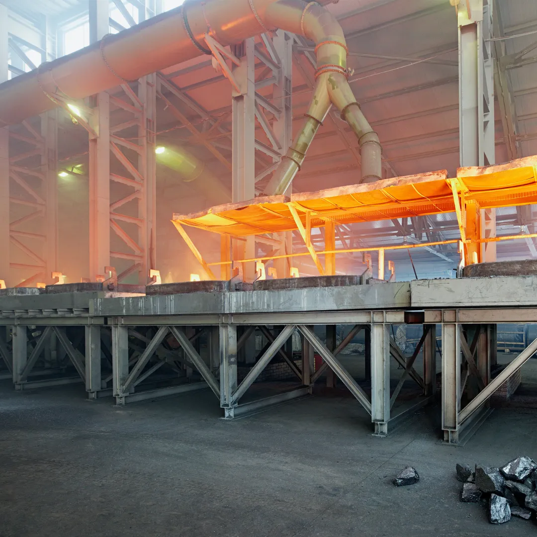 Interior of an industrial facility with large machinery and bright overhead lighting.