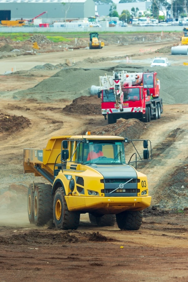 Construction equipment and vehicles at a mining site.
